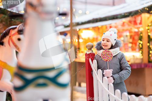 Image of girl with lollipop at christmas market