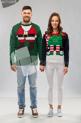 Image of happy couple at christmas ugly sweater party