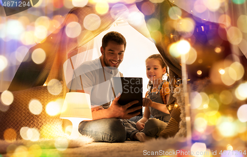 Image of family with tablet pc in kids tent at home