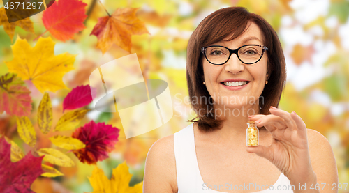 Image of senior woman with gold facial mask in bottle