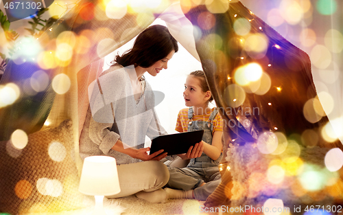 Image of family with tablet pc in kids tent at home