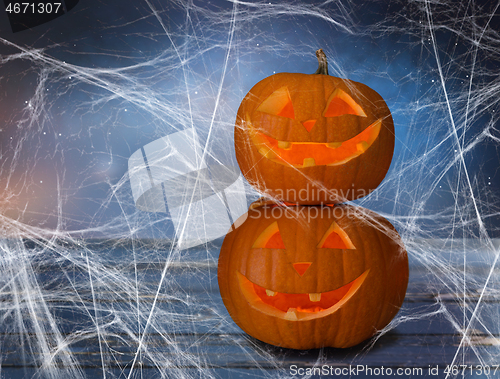 Image of two pumpkins or jack o lanterns and spiderweb