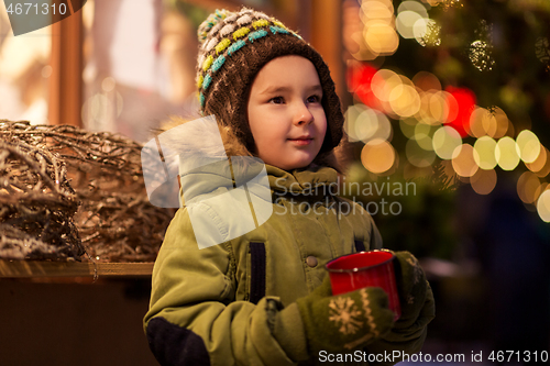 Image of happy boy with cup of tea at christmas market