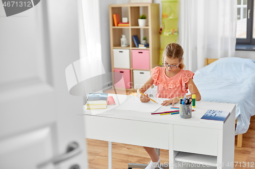 Image of student girl drawing with pencil at home