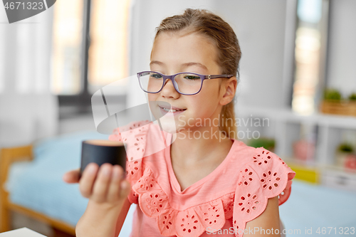 Image of student girl using smart speaker at home