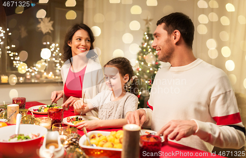 Image of happy family having christmas dinner at home