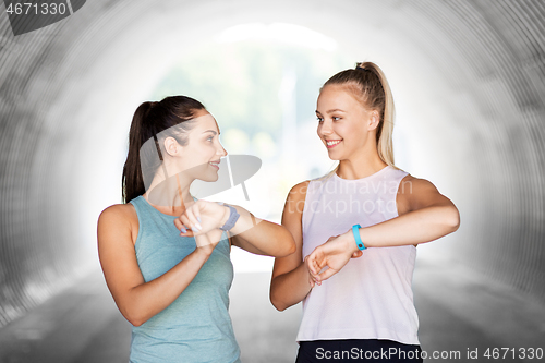 Image of women or female friends with fitness trackers