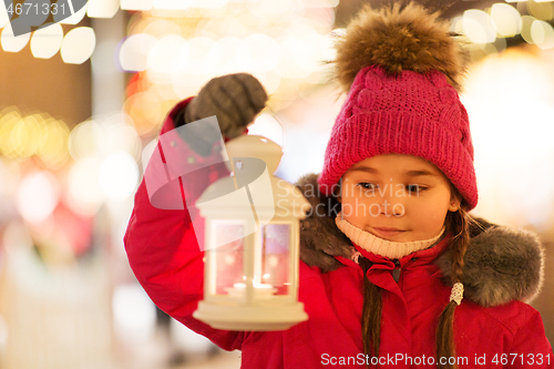 Image of happy little girl at christmas with lantern market