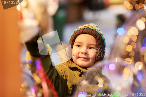 Image of happy little boy at christmas market in winter