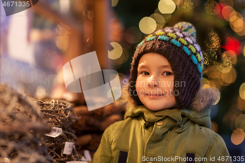 Image of happy little boy at christmas market in winter