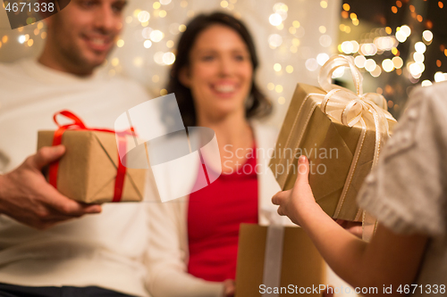 Image of close up of family with christmas gifts at home