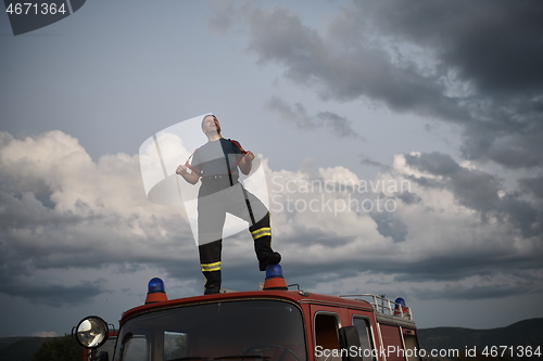 Image of firefighter out of duty on top of truck