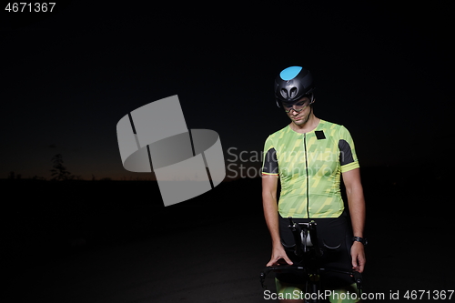 Image of triathlon athlete portrait while resting on bike training