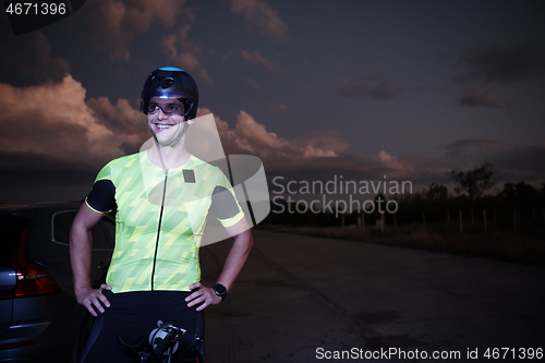 Image of triathlon athlete portrait while resting on bike training