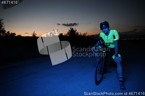 Image of triathlon athlete portrait while resting on bike training