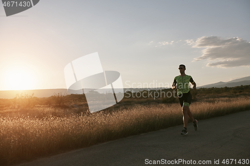 Image of triathlon athlete running on morning trainig