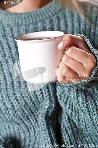 Image of Female hands holding mug of hot tea with lemon in morning.