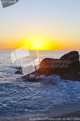 Image of Sunset on the rocky shore.