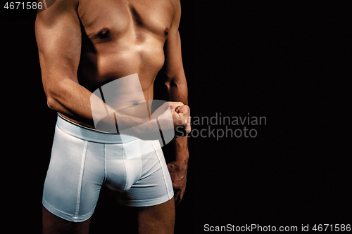 Image of man in white briefs with a fist