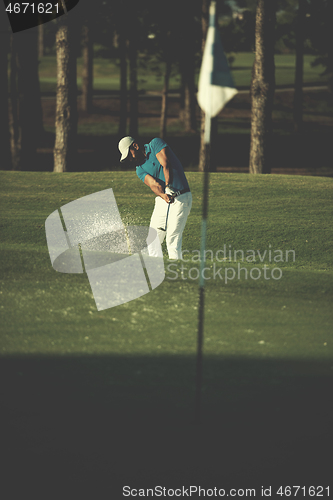 Image of pro golfer hitting a sand bunker shot