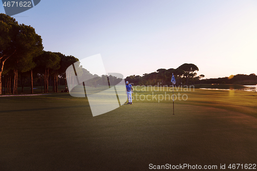 Image of golfer hitting ball to hole