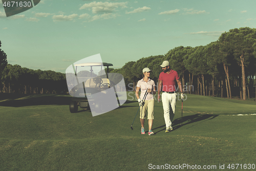 Image of couple walking on golf course