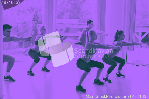 Image of Group of people exercising at the gym