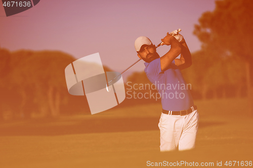 Image of pro golfer hitting a sand bunker shot