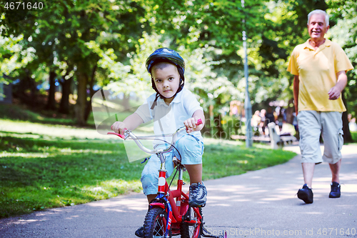 Image of grandfather and child have fun  in park