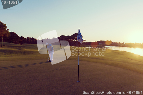 Image of golfer hitting ball to hole