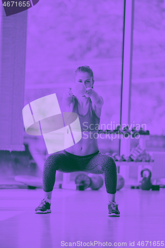 Image of weights lifting  and working on her biceps in a gym