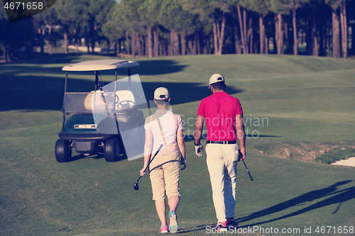 Image of couple walking on golf course