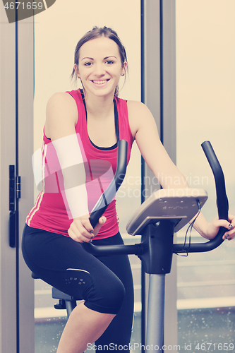 Image of womanworkout  in fitness club on running track machine