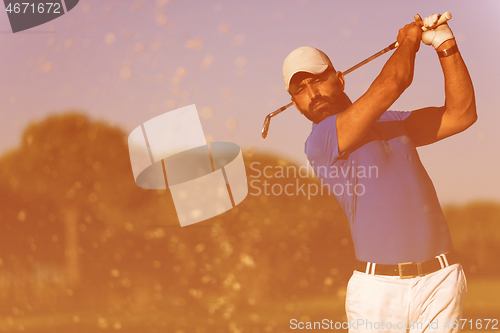 Image of pro golfer hitting a sand bunker shot