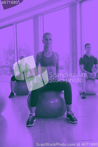 Image of group of people exercise with balls on yoga class