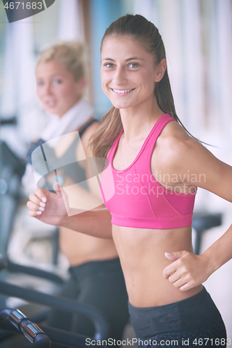 Image of woman exercising on treadmill in gym