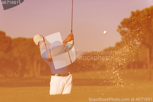 Image of pro golfer hitting a sand bunker shot