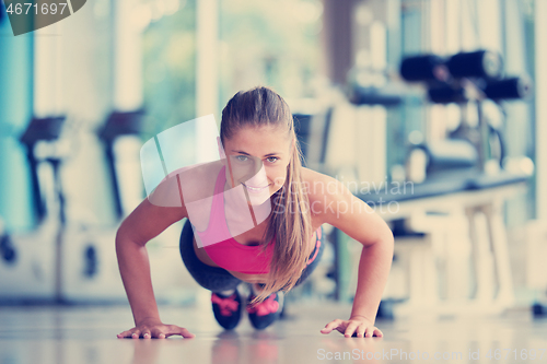 Image of warming up and doing some push ups a the gym