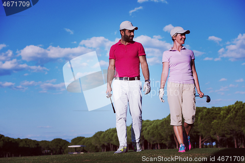 Image of couple walking on golf course