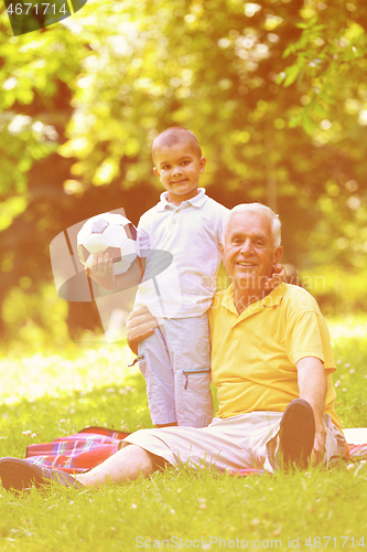 Image of happy grandfather and child in park