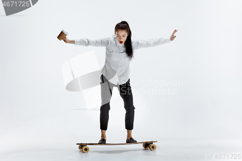 Image of businesswoman riding skate on white background