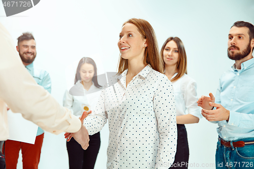 Image of Boss approving and congratulating young successful employee