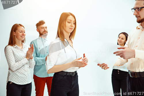 Image of Boss approving and congratulating young successful employee