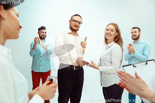 Image of Boss approving and congratulating young successful employee