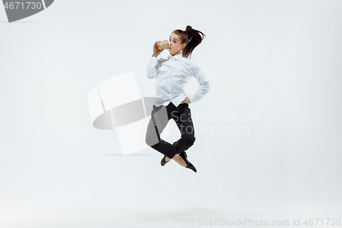 Image of Happy business woman dancing and smiling isolated on white.