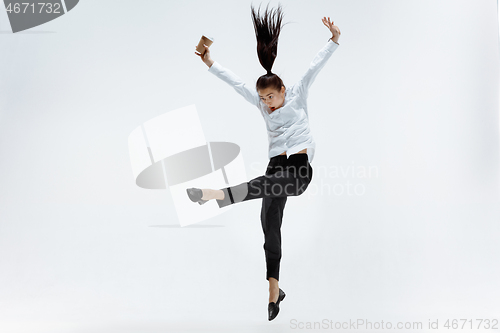 Image of Happy business woman dancing and smiling isolated on white.