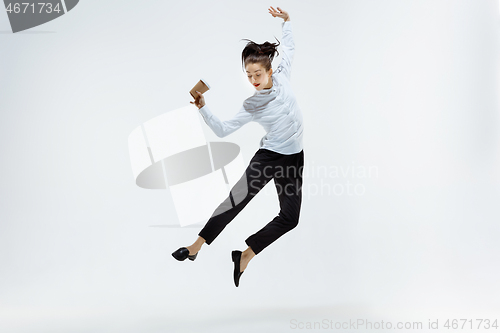 Image of Happy business woman dancing and smiling isolated on white.