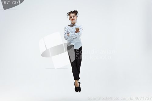 Image of Happy business woman dancing and smiling isolated on white.