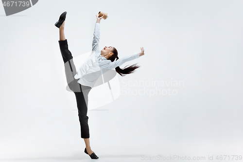 Image of Happy business woman dancing and smiling isolated on white.