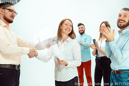 Image of Boss approving and congratulating young successful employee